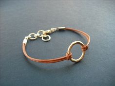 "dainty bracelet made with matte 16K gold plated over brass little hoop and Marigold leather cord bracelet measures total 7.5\" with 1\" extension chain and closed with gold plated lobster clasp hoop measures 15mm diameter bracelet can be made to any length plus 1\" extension chain so you can adjust length, simply leave a note to seller while check out otherwise you'll get 6.5\" plus 1\" extension chain. matching necklace; https://www.etsy.com/listing/62658576/matte-yellow-gold-hoop-pendant-neck Adjustable Everyday Jewelry With Gold Clasp, Gold Bracelets With Adjustable Waxed Cord, Gold Bracelet With Adjustable Waxed Cord, Gold Bracelets With Adjustable Cord For Everyday, Adjustable Matte Gold Minimalist Bracelet, Adjustable Brown Hoop Jewelry, Gold Waxed Cord Bracelets For Gifts, Adjustable Circular Everyday Jewelry, Adjustable Gold Bracelet With Waxed Cord