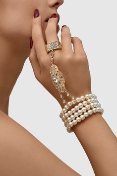 This sumptuous piece of jewelry features a retro-elegant yet slightly modern style that complements the lavish garments, reminiscent of the roaring 1920s. Features: High quality Austrian crystals and imitation pearls Four strand design Inner perimeter of bracelet is 7.4"/ 18.8cm Diameter of ring: 0.7"/ 1.78cm Evening Pearl Bracelet Jewelry, Elegant Jeweled Metal Crystal Bracelet, Elegant Jeweled Crystal Bracelet For Party, Elegant Jeweled Crystal Bracelet, Pearl White Bracelet Jewelry For Party, Vintage Pearl Bracelets For Parties, Luxury Adjustable Pearl Bracelet For Party, Pearl Bracelet Jewelry For Parties, Pearl Bangle Jewelry For Party