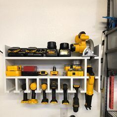 there are many tools on the shelves in this garage, including drillers and screwdrivers