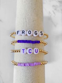 four bracelets with the words frogs, tcu and frog on them