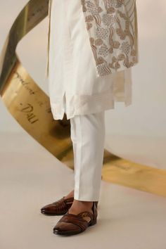 Editor's Note Featuring the new dali dirty ivory shrug set curated using four different types of embroidery. This ivory and gold-based ensemble is perfect for your day's wedding festivities. Paired with a matching front open kurta and tapered trousers. Fabric: Linen silk Color: Ivory Components: Shrug, kurta, trousers Occasion: Wedding guest Fit: Regular Note: Product colour may slightly vary due to photographic lighting sources Care: Dry clean only About the Designer After establishing himself Different Types Of Embroidery, Jatin Malik, Blouse Yoke, Wedding Festivities, Dhoti Pants, Nehru Jackets, Types Of Embroidery, Tapered Trousers, Indian Wedding Outfits