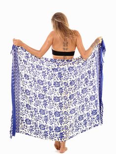 Enhance your look with this floral sarong with fringed edges. Easy to tie and many ways to wear the cover-up. Don't limit yourself. Using the ancient batik technique to print, colors may slightly vary due to process. Semi-sheer Lightweight 67x45 inches Made of soft rayon Hand soak in cold water before first wear Bohemian Floral Print Shawl For Summer, Bohemian Batik Print Sarong For Festival, Bohemian Printed Sarong For Beach, Bohemian Printed Beach Sarong, Bohemian Printed Sarong For Poolside, Traditional Summer Beach Shawl, Bohemian Beach Sarong With Block Print, Summer Vacation Sarong With Block Print, Summer Vacation Block Print Sarong