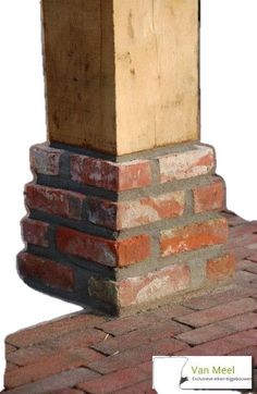 a brick chimney with a wooden block on top