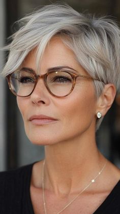 Pixie hairstyles for women over 50 are ideal for those who love short hair with a lot of character. Go for a textured pixie to create volume, or keep it sleek and smooth for a polished look. These styles suit all face shapes and hair textures, adding a modern edge to your overall appearance. Short Gray Pixie Haircuts, Short Hairstyle Women Glasses, Short Pixie Grey Hair, Grey Pixie Haircut Older Women, Short Grey Hair Over 60 With Glasses, Short Grey Hair Over 50 Modern Haircuts, Short Sassy Hair Over 50, Gray Pixie Haircut, Pixie Round Face