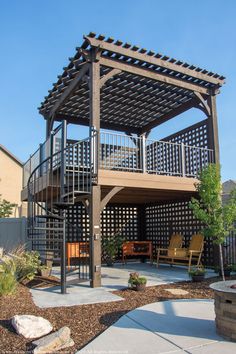 a patio with a wooden pergolan and chairs