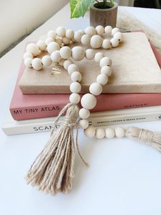 a tasseled bookmark and rosary on top of two books