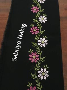 a black table runner with pink and white flowers on it that says stay new steps