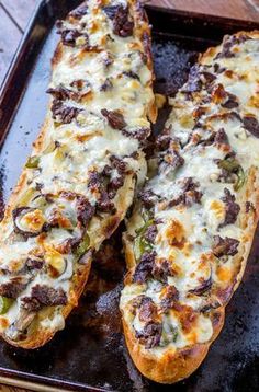 two long pieces of bread with cheese and toppings