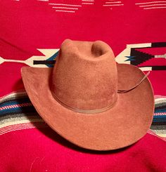 Vintage "Beaver Hats Co." cowboy hat in rare rust/burgundy/brown color. In good vintage condition but does have some slight discoloration staining around the base of the crown, most likely from some adhesive for a retro-fitted feather hat band found with this hat. Am including a new feather hat band with sale and can be put on if desired. (I believe the adhesive can be removed with a bit of effort but I'm not wanting to try) Selling as is. It still looks great. These hats are sought after for th Cowboy Oc, Feather Hat Band, Beaver Hat, Feather Hat, Hat Band, Cowboy Hat, The Crown, Oklahoma, Brown Color