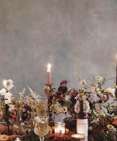 the table is set with candles and flowers