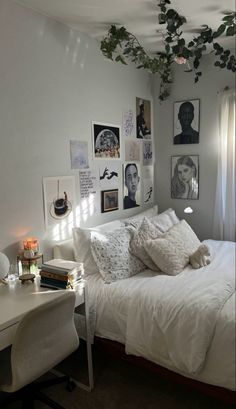 a white bed sitting in a bedroom next to a desk