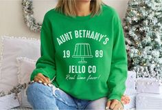 Aunt Bethany's Jello Co sweatshirt Gildan Crewneck Sweatshirt Perfect for any Christmas Vacation fan! Shitter's Full! Fits true to size. For an oversized fit, size up. Be sure to check the size chart in the listing. Ideal for any situation, a unisex heavy blend crewneck sweatshirt is pure comfort. These garments are made from polyester and cotton. This combination helps designs come out looking fresh and beautiful. The collar is ribbed knit, so it retains its shape even after washing. There are Christmas Vacation Costumes, Aunt Bethany, Shitters Full, Reindeer Christmas Sweater, Cousin Eddie, Clark Griswold, Funny Matching, Jeans Coat, Lampoons Christmas