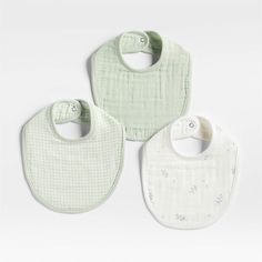 three bibs in white and light green with small stars on the front, two are blank