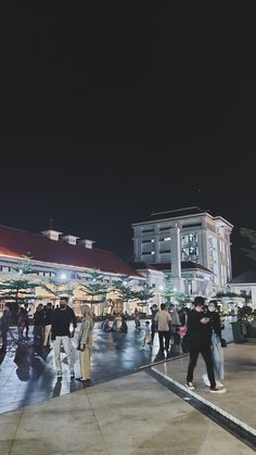 many people are walking around in the city at night