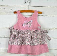 This listing is for a baby girls Sz 12 18m (check measurements as there is no size) pink floral sleeveless dress by Dee Stehl.  This has a bunny applique on the front, ric rac trim & a tie on each side.  This is in gently pre-owned condition.  Chest measures 10" Length measures 15" - shoulder to bottom hem ~ Sweet Bugs Boutique ~ ~Payment~  * Payment must be received within 5 days of purchasing or item will be relisted & non-paying bidder will be filed. * I accept PayPal only. * I offer combined Cute Sleeveless Pinafore Dress For Playtime, Cute Sleeveless Pinafore Dress With Ruffles, Summer Sleeveless Pinafore Dress For Playtime, Cute Pink Sleeveless Pinafore Dress, Cute Sleeveless Pink Pinafore Dress, Bunny Applique, Vintage Childrens Clothing, Floral Sleeveless Dress, Ric Rac