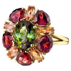 This happy ring designed with a kaleidoscope of gems is sure to make you smile! A vivid green tourmaline oval is encircled by rounded pear-shaped garnets and marquise shaped precious topazes in a unique combination of gemstone colors and shapes that will be your "go to" ring for fall, or anytime you want to lift your spirits! Handmade in 18k yellow gold by our jewelers in Los Angeles. Green tourmaline, 10.05 x 8.11mm, 2.92 carats Rounded pear shaped garnets, 6.00 x 6.00mm, 4.29 carat total Marquise shaped precious topazes, 6.00 x 3.00mm, 1.56 carat total Ring size 7 Complimentary sizing as needed Yellow Gold Cocktail Ring, Topaz Yellow, Gold Jewelry Outfits, Vintage Cocktail Ring, Tourmaline Jewelry, Precious Jewels, Brooch Necklace, Silver Plated Jewelry, Fabulous Jewelry