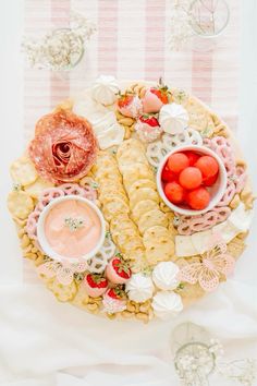 a platter filled with different types of food on top of a white table cloth