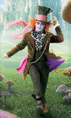 there is a man dressed as the mad hatter running in front of some mushrooms