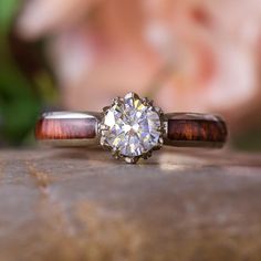 a diamond ring sitting on top of a wooden table