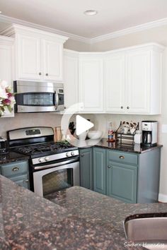 a kitchen with granite counter tops and white cabinets