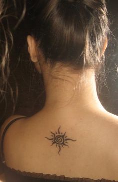 a woman with a sun tattoo on her back