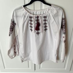 Handmade In Ukraine Where I Am From Excellent Condition Embroidered Detailing All Proceeds For Ukraine Underarm To Underarm 21 Inches Sleeve Length 15 Inches White Long Sleeve Blouse With Intricate Embroidery, White Folk Tops With Geometric Embroidery, White Peasant Top With Floral Embroidery, Bohemian White Peasant Top With Embroidered Sleeves, White Bohemian Peasant Top With Embroidered Hem, White Floral Embroidered Peasant Top, White Bohemian Peasant Top With Embroidered Sleeves, White Embroidered Folk Peasant Top, White Folk Top With Embroidered Hem