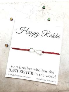 a red string bracelet that says happy rakii to a brother who has the best sister in the world