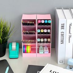 a desk with various office supplies on it and a potted plant in the corner