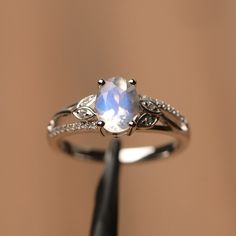 It is natural moonstone ring, the main stone is about 6mm*8mm, oval cut, The basic metal is sterling silver and plated with rhodium. To change the metal to a solid gold (white/rose) or platinum is also available, please ask for a quotation if you want. You can also go to my shop Home for more elegant rings: https://www.etsy.com/shop/godjewelry?ref=hdr_shop_menu More alexandrite rings: https://www.etsy.com/shop/godjewelry?ref=seller-platform-mcnav&search_query=moonstone Customization is alway Oval White Moonstone Ring With Diamond, Elegant White Gold Moonstone Ring With Accent Stones, White Gold Sterling Silver Moonstone Ring With Prong Setting, Elegant White Moonstone Ring, Oval Cabochon, Oval Diamond White Moonstone Ring For Anniversary, White Oval Cabochon Moonstone Ring, Elegant White Moonstone Ring With Oval Cabochon, Elegant White Oval Cabochon Moonstone Ring, White Oval Cabochon Moonstone Ring For Anniversary