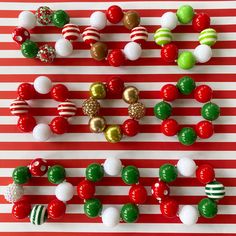 christmas ornaments are arranged on a red and white striped background, including candy canes