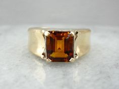 This fantastic ring is straight from the mid-1900's, and though designed for a man, it makes a great cocktail ring for the right lady! We've set this piece with a new, warm and glowing citrine in a bezel of reflective white gold. Handsome and sleek, this autumn hued ring would make a great gift for any occasion. Metal: 14K Yellow Gold and White Gold Gem: Citrine 2.16 Carats Gem Measurements: 7.2 x 8.9 mm, Rectangle Emerald Cut Ring Size: 7 Marks: "<14KT>" Stamped on the inside band Elegant Citrine Signet Ring For Formal Occasions, Elegant Formal Citrine Signet Ring, Timeless Citrine Rings For Formal Occasions, Classic Amber Topaz Ring For Anniversary, Classic Brown Signet Ring For Anniversary, Elegant Brown Signet Ring For Anniversary, Brown Polished Finish Signet Ring For Formal Occasions, Formal Brown Signet Ring With Polished Finish, Classic Amber Rings For Formal Occasions