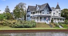 a large house sitting next to a body of water