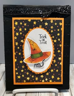 a trick or treat bag with a witch hat on it and stars around the edges