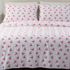 a bed with red and white bedspreads on it