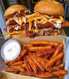 two burgers and french fries are sitting on a table