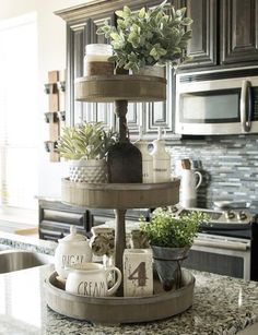 three tiered cake stand in a kitchen with granite counter tops and stainless steel appliances