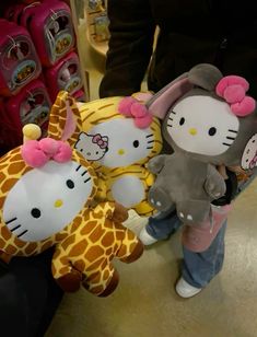 hello kitty stuffed animals are on display in a store