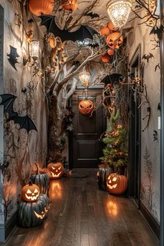 an entry way decorated for halloween with pumpkins and bats on the door, lights hanging from the ceiling