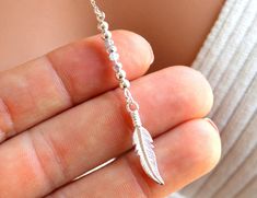 "This is a beautiful Lariat Y style gold filled feather pendant necklace. Necklace features 3mm mystic Austrian crystals and 1\" sterling silver feather pendant at the end of a 3.25\" drop. This necklace comes in a 16\", 18\", 20\" or 22\" length. The length is the measurement around the neck only. If you require a shorter drop please just leave me a note at checkout. This necklace simple yet very stylish! One of my personal favorites. Comes nicely boxed, the perfect gift! Model is wearing an 18 14kt Gold Jewelry, Feather Pendant Necklace, Delicate Necklaces, Necklaces Women, Unique Jewelry Gifts, Jewelry Care Instructions, Clover Necklace, Feather Pendant, Silver Feather