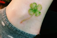 a small four leaf clover tattoo on the ankle