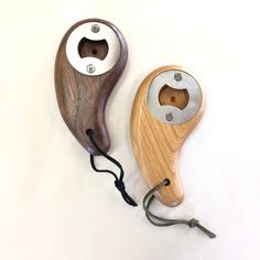 two different types of wood shaving tools on a white surface with a cord attached to the handle