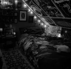 black and white photograph of a bedroom with lights on the ceiling