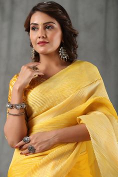 Minimal and stylish yellow stripes tussar silk saree is a perfect choice for parties! The saree comes with a beautiful bandhej embroidered saree blouse. Disclaimer: The actual product may vary slightly from the image. These are custom orders, hence expect slight variation in color, placement of the motif or buta. ESTIMATED DELIVERYBecause this is a custom order, it would take about 4 weeks from the date of purchase. RETURN POLICYThis product is a custom order and cannot be returned or exchanged. Embroidered Saree Blouse, Embroidered Saree, Wedding Sarees, Fashion Journals, Tussar Silk Saree, Traditional Fabric, Silk Sarees Online, Saree Online, Designer Sarees