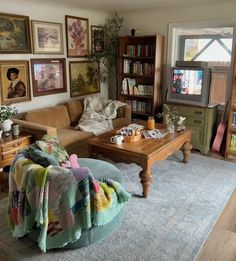 a living room filled with furniture and pictures on the wall