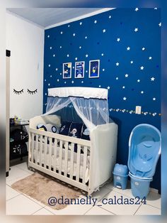 a baby's room decorated in blue and white with stars on the wall, crib bedding, and toys