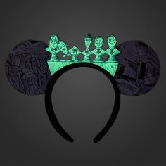 a mickey mouse ears headband with green glow in the dark characters on it's ears