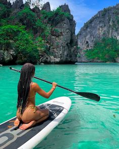 a woman sitting on top of a surfboard in the ocean