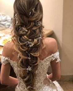 a woman with long hair in a wedding dress looking at the back of her head