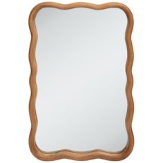 a wooden frame mirror sitting on top of a white wall