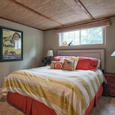 a bedroom with a bed, nightstands and pictures on the wall